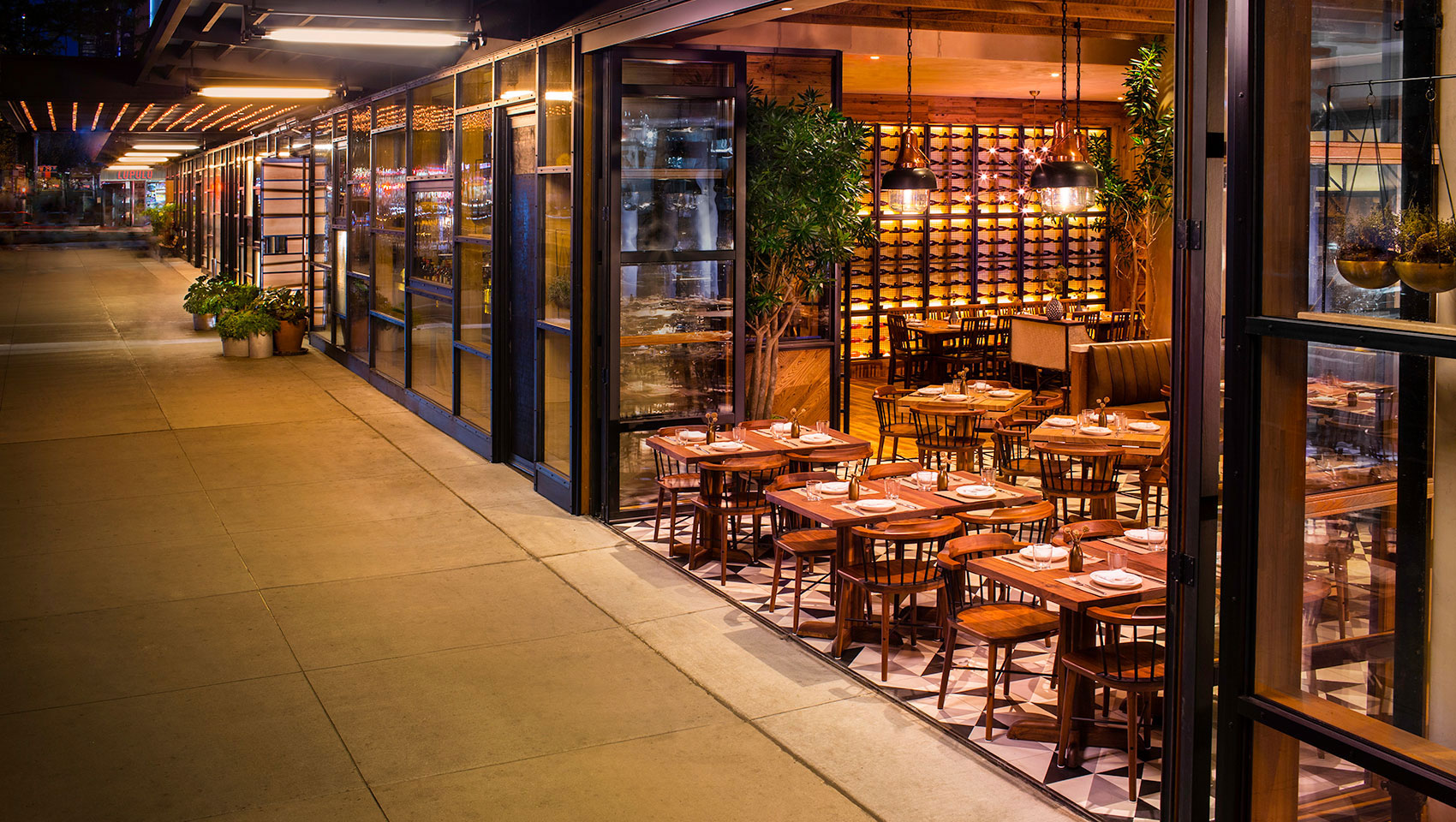 L'Amico restaurant open design with open doors and outdoor seating on sixth avenue