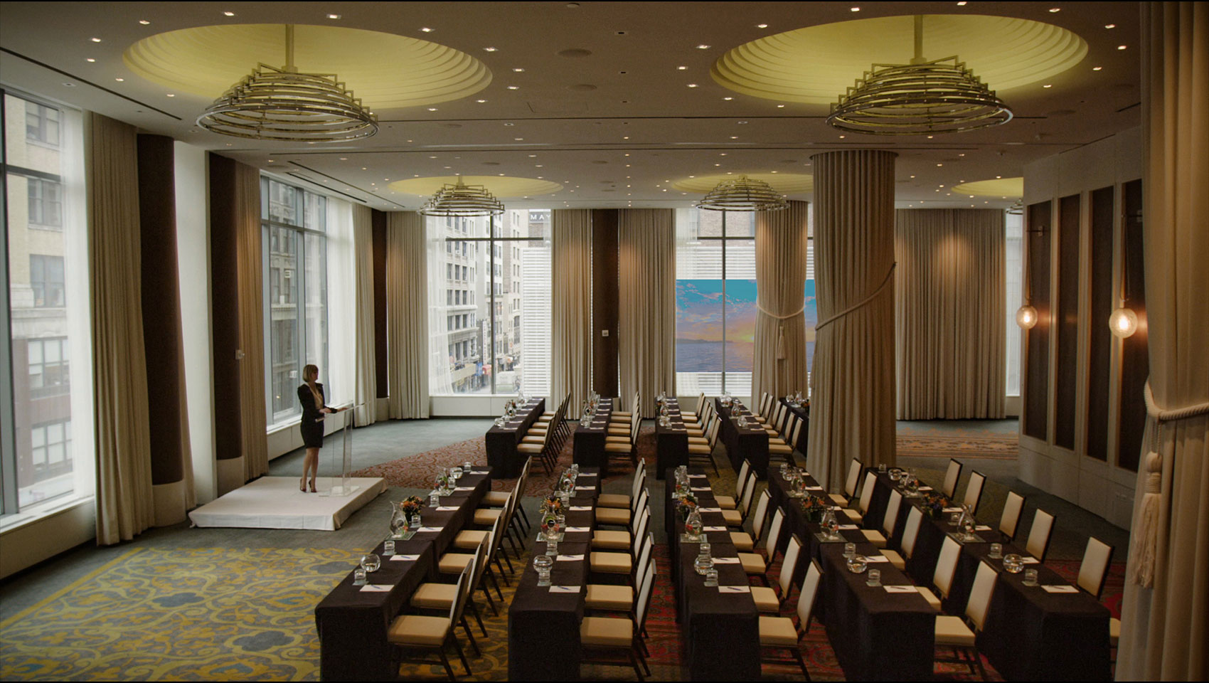 Ventana Ballroom with classroom setup underneath circular fixtures with presenter at front podium