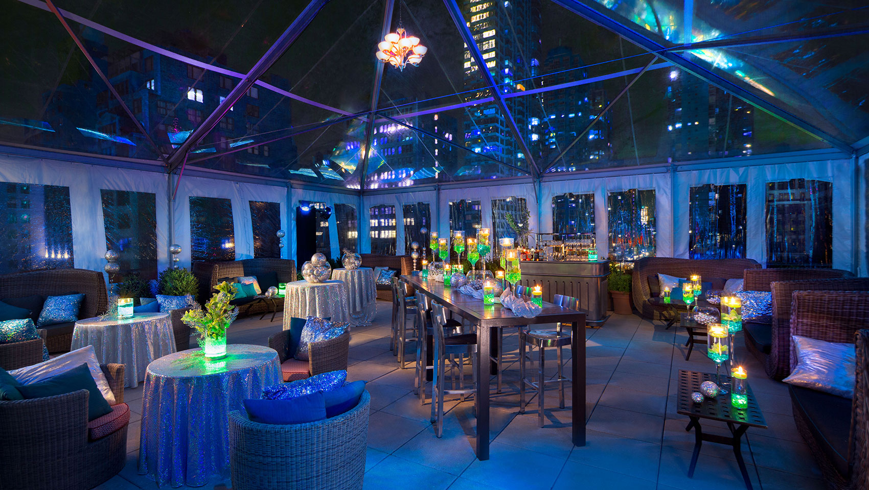Veranda South tented wedding reception with tables underneath tent with visible views of surrounding skyscrapers