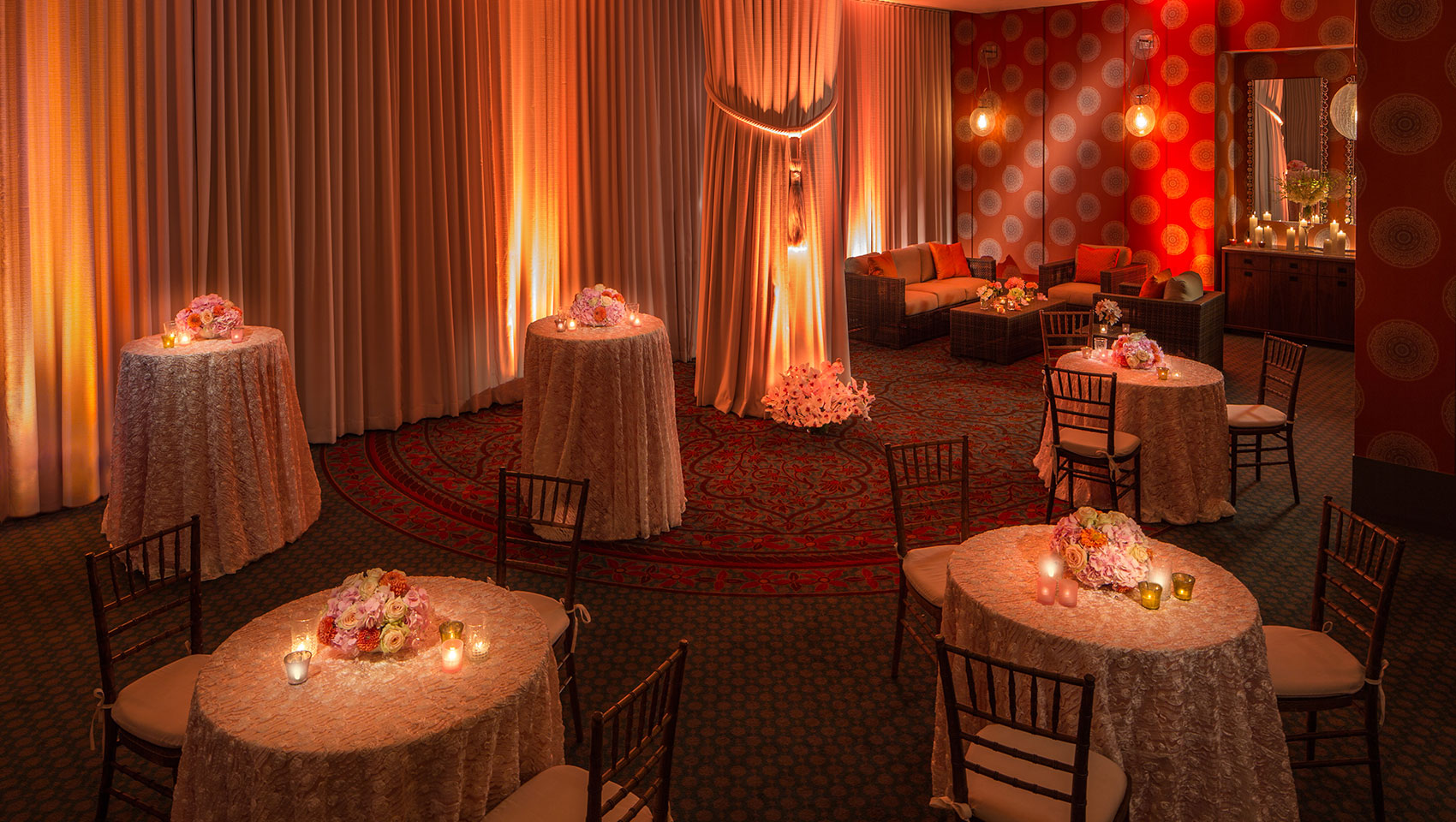 Verdi I wedding set up with circular tables with floral arrangements and candles