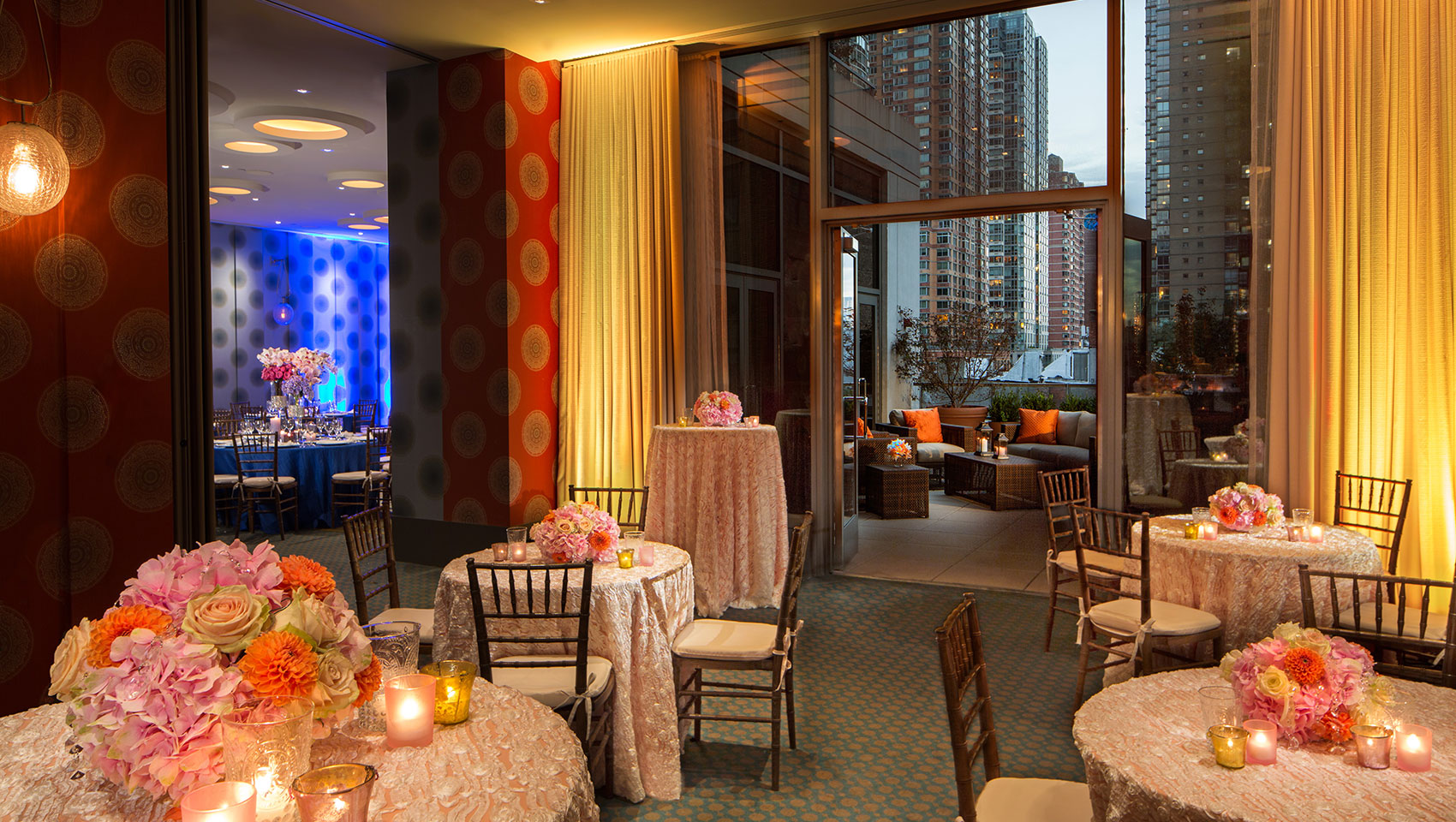 Verdi I, II, and Terrace area set up for wedding reception with circular tables and open balcony area overlooking city views