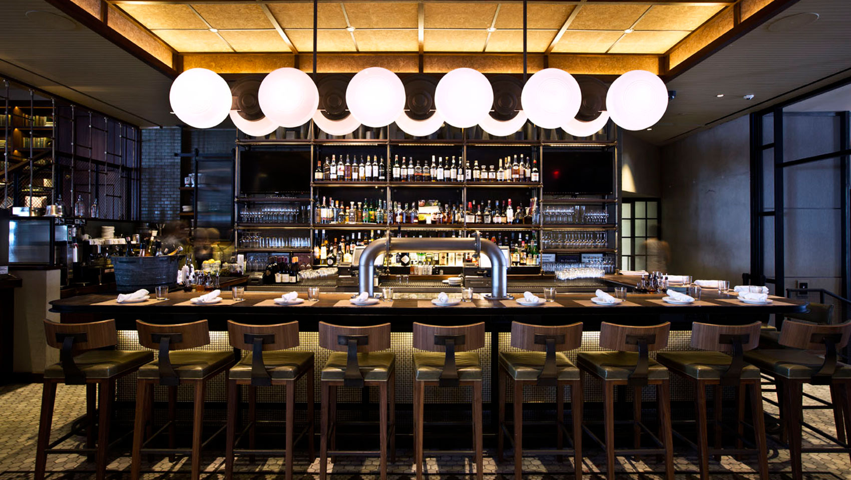 The Vine bar seating underneath circular light fixture