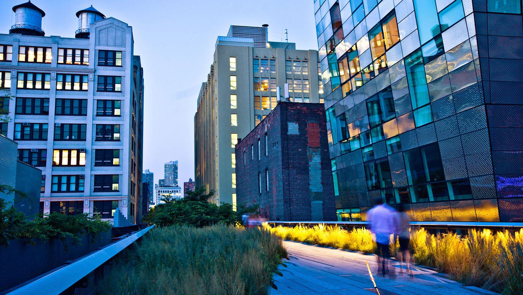 people walking in a business park at dusk
