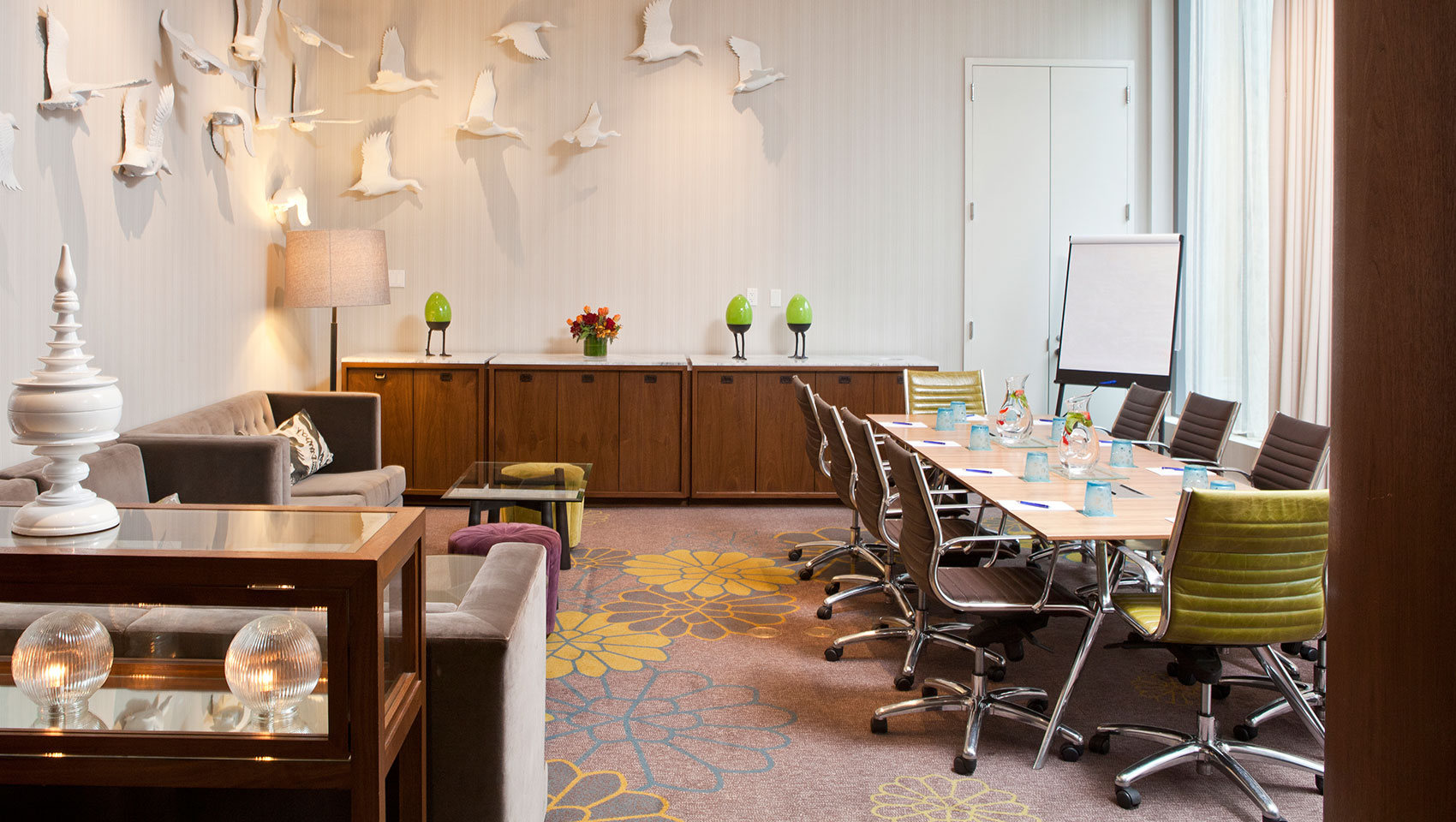 Invent I meeting space with meeting table set with glasses and notepads in sunlit room