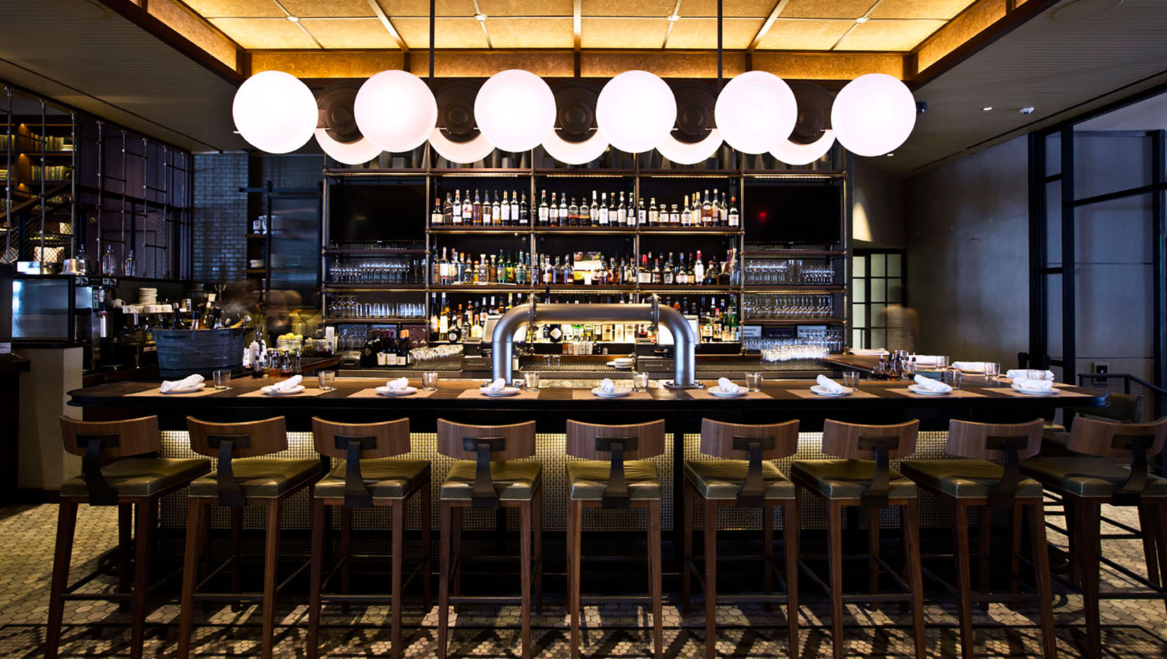 The Vine bar seating underneath circular light fixture