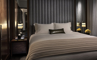 King deluxe guestroom bed with 2 adjacent nightstands and accent pillow