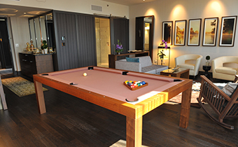 Live suite living area showing pool table next to seating