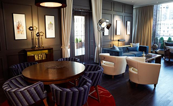 Veranda suite living area with wooden round table next to open area seating