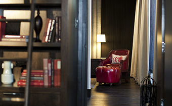 Leather accent chair with matching ottoman seen through a door frame