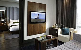 Kimpton Hotel Eventi Premier One Bedroom Suite bathroom with marble finish bathtub and countertop area